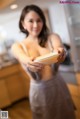 A woman holding a bowl of food in her hands.