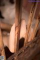 A close up of a person's hand on a wooden chair.